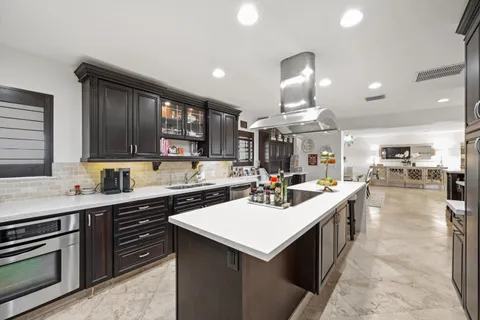 a kitchen with stainless steel appliances a sink stove and cabinets
