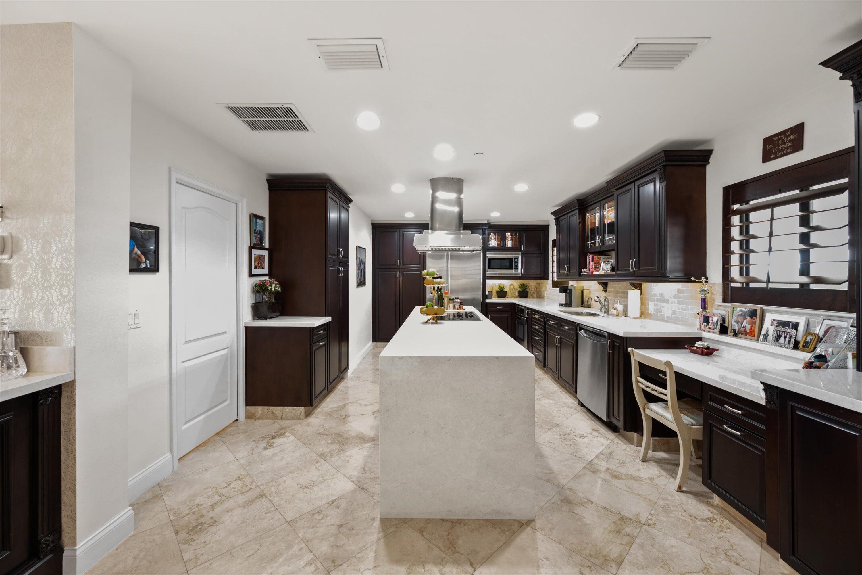 16910 Bay Street, Unit E 502 Jupiter, FL 33477 - Photo 23 of 43 a large white kitchen with lots of counter space a sink appliances and cabinets