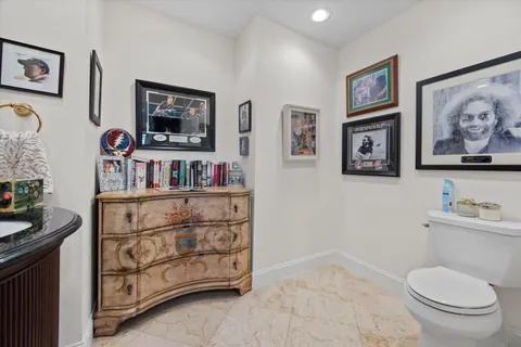 a bathroom with a toilet a sink and a mirror