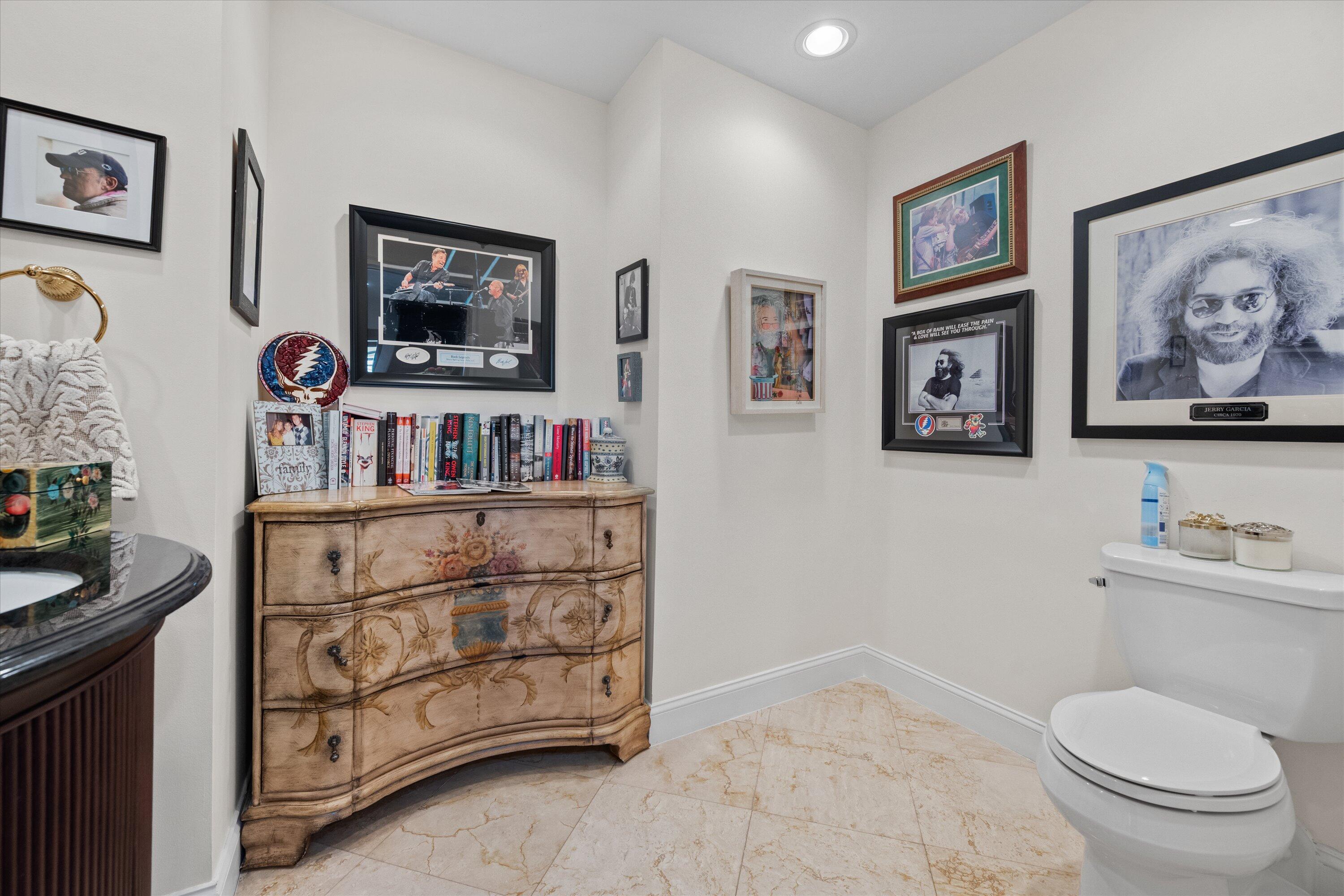16910 Bay Street, Unit E 502 Jupiter, FL 33477 - Photo 24 of 43 a bathroom with a toilet a sink and a mirror