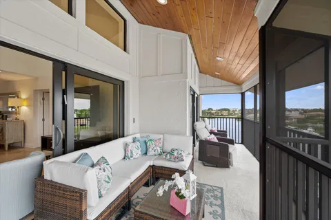 a living room with furniture and a floor to ceiling window