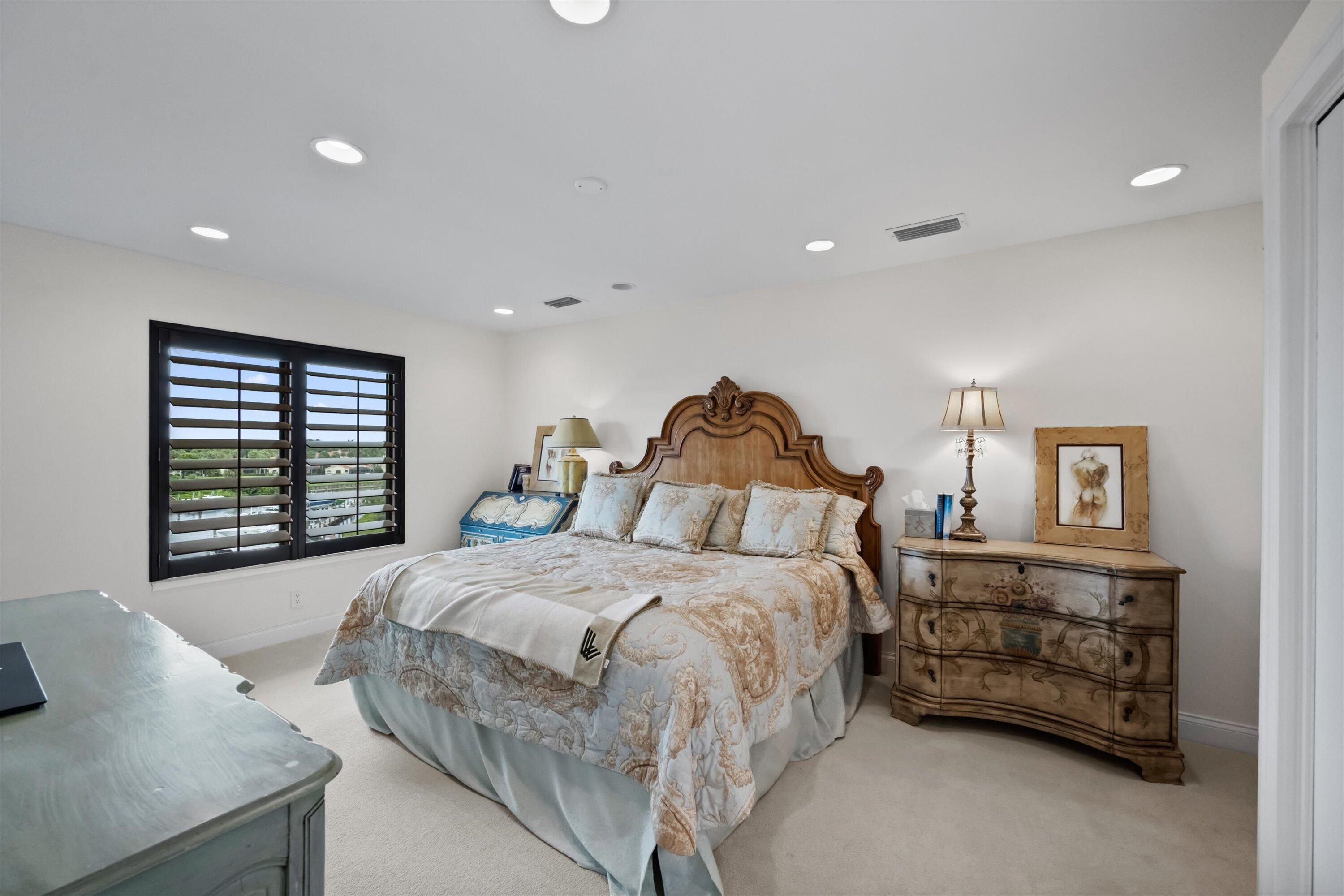 16910 Bay Street, Unit E 502 Jupiter, FL 33477 - Photo 29 of 43 a bedroom with a bed and a couch