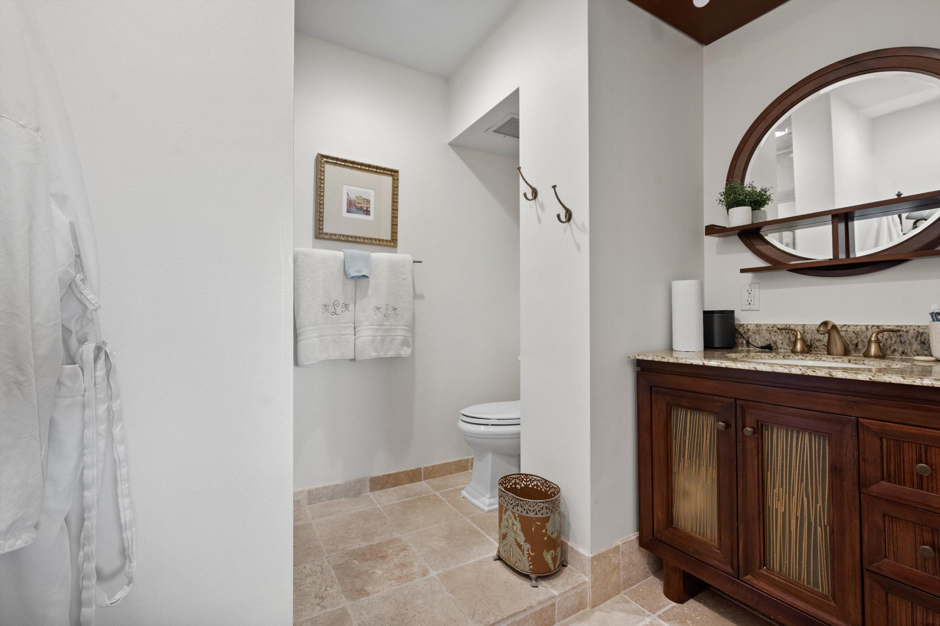 16910 Bay Street, Unit E 502 Jupiter, FL 33477 - Photo 31 of 43 a bathroom with a granite countertop toilet and a sink