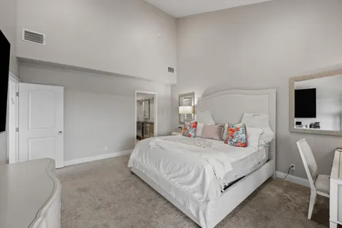 a bed room with a bed and a large window