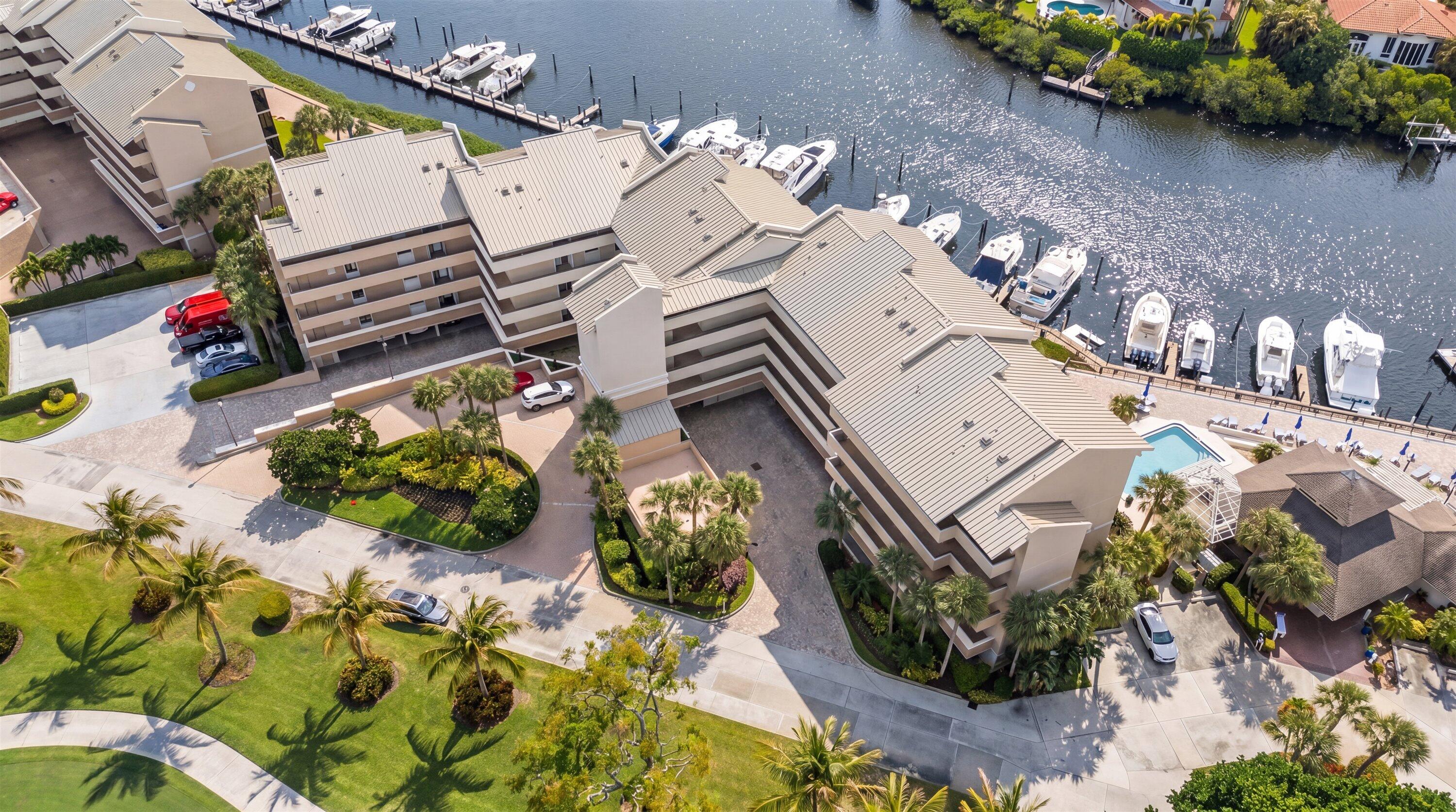 16910 Bay Street, Unit E 502 Jupiter, FL 33477 - Photo 38 of 43 an aerial view of a house with a yard and a large tree