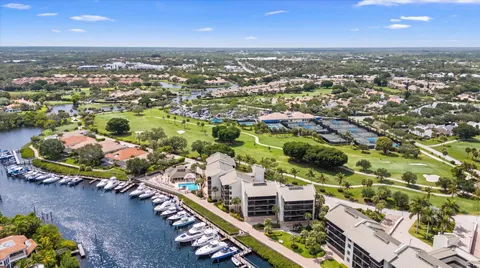 an aerial view of lake and residential houses with outdoor space