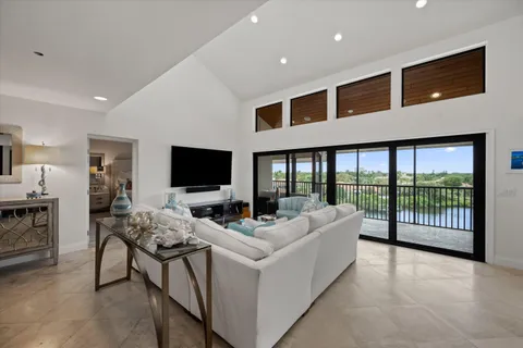 a living room with furniture tv and a flat screen tv