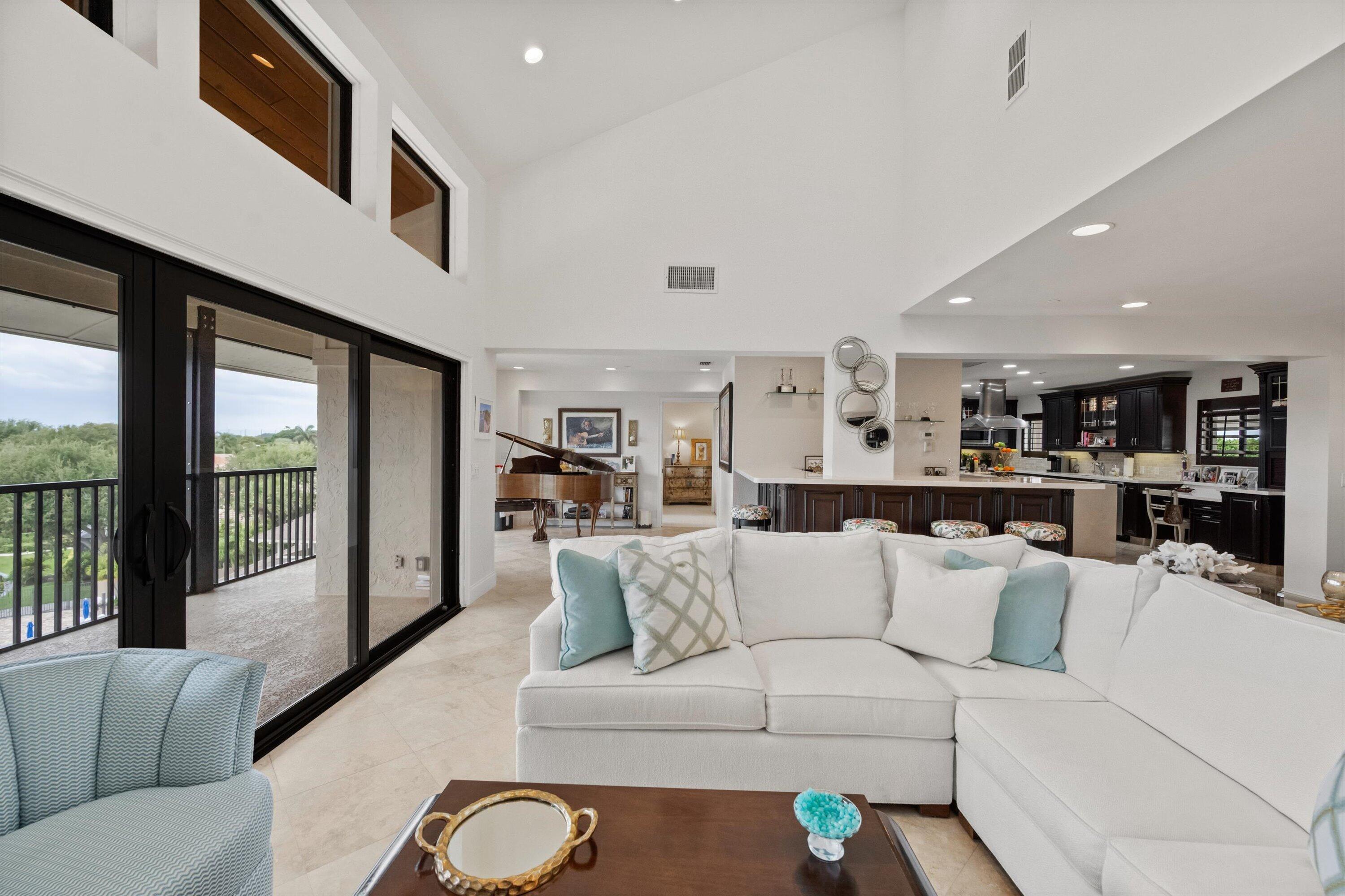 16910 Bay Street, Unit E 502 Jupiter, FL 33477 - Photo 6 of 43 a living room with furniture and a large window