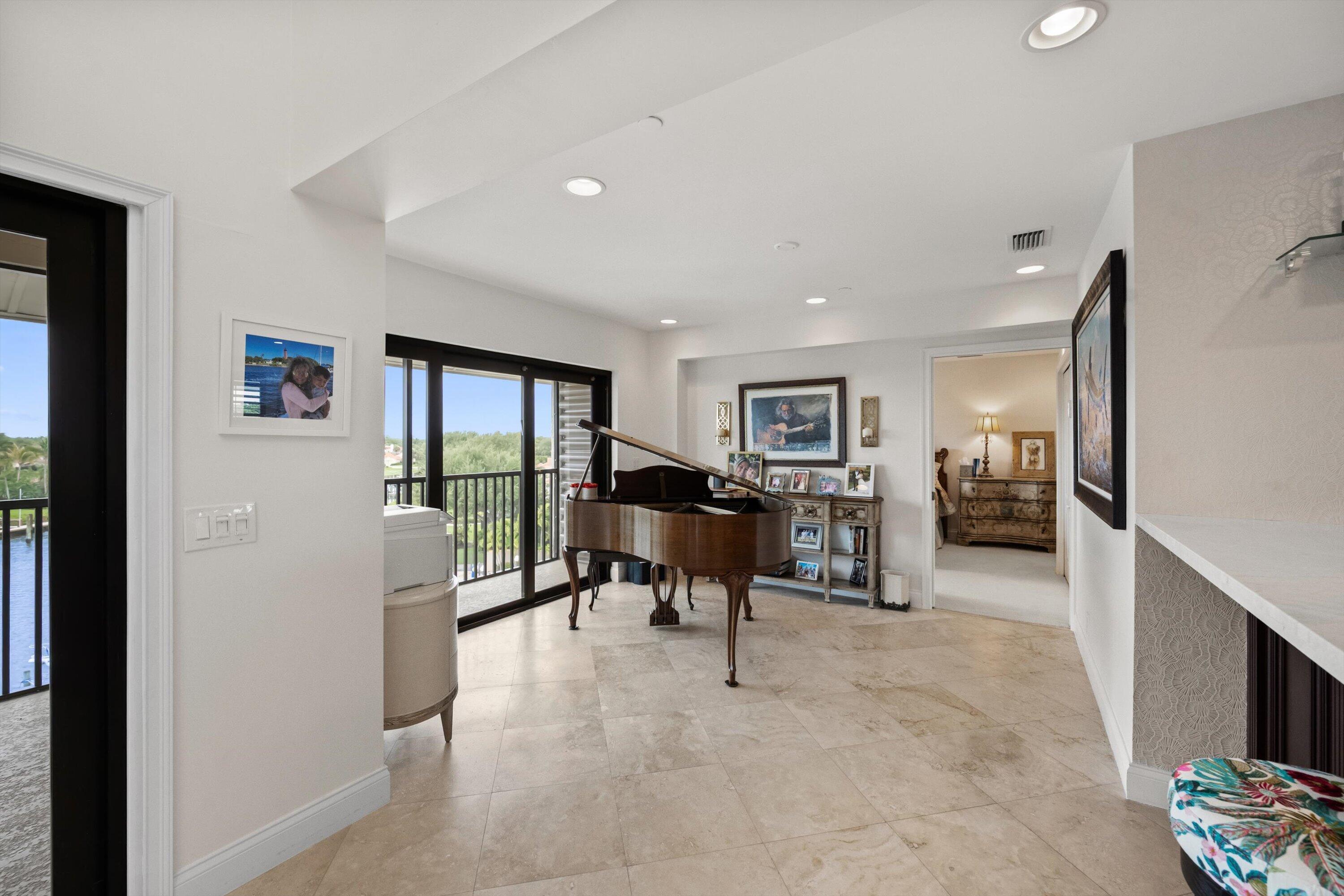 16910 Bay Street, Unit E 502 Jupiter, FL 33477 - Photo 9 of 43 a living room with furniture and a flat screen tv