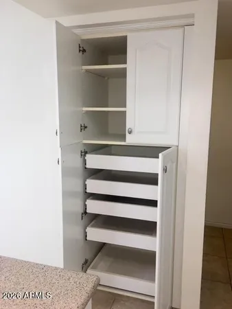 a view of closet area with empty racks