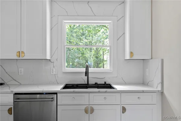 a kitchen with appliances cabinets and a window
