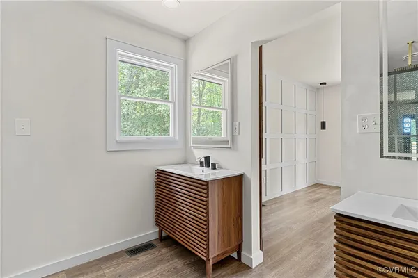 a bathroom with a sink a mirror and a bathtub