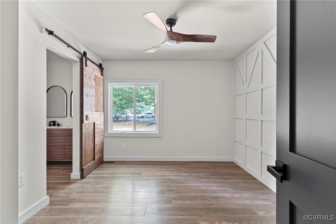113 Rappa Run Road Topping, VA 23169 - Photo 31 of 49 Unfurnished bedroom featuring a barn door, light w