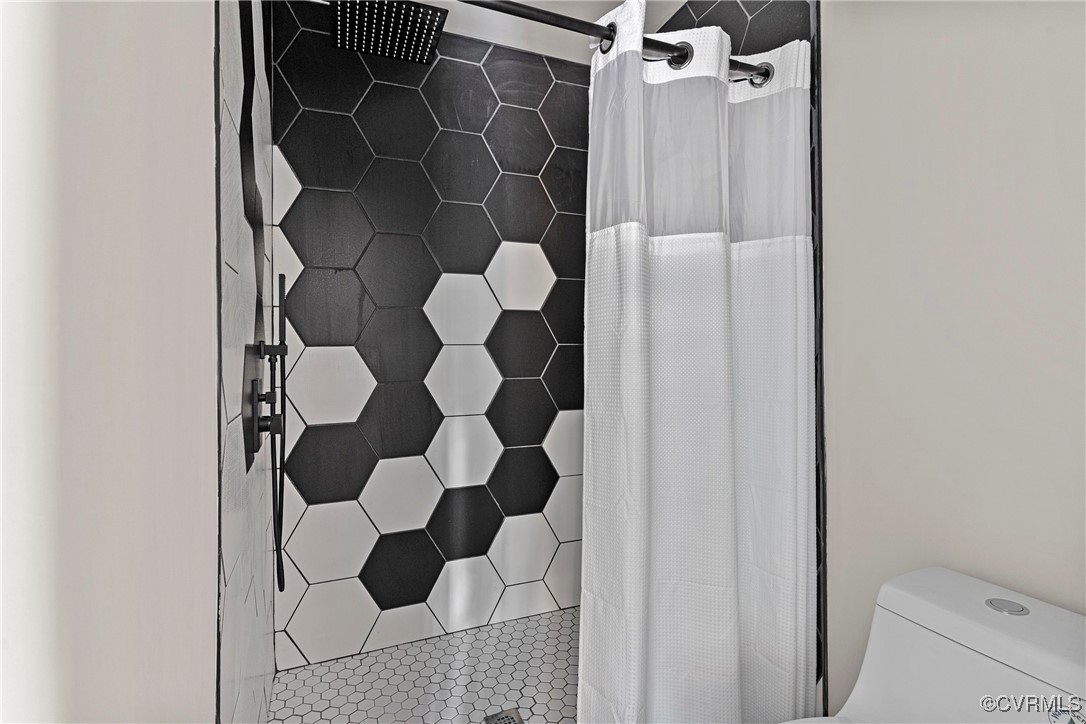 113 Rappa Run Road Topping, VA 23169 - Photo 35 of 49 Bathroom with a tile shower and tile patterned flo