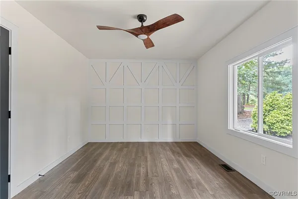 wooden floor in an empty room with a window