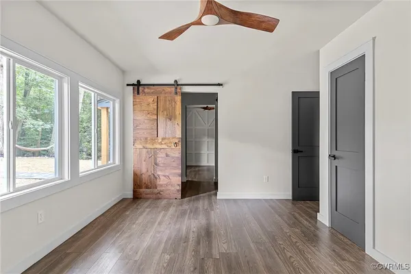 a view of a livingroom with wooden floor and a window