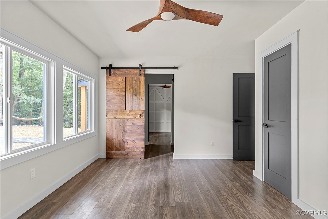 113 Rappa Run Road Topping, VA 23169 - Photo 37 of 49 Unfurnished bedroom with multiple windows, dark wo