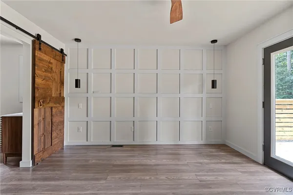 an empty room with wooden floor and closet