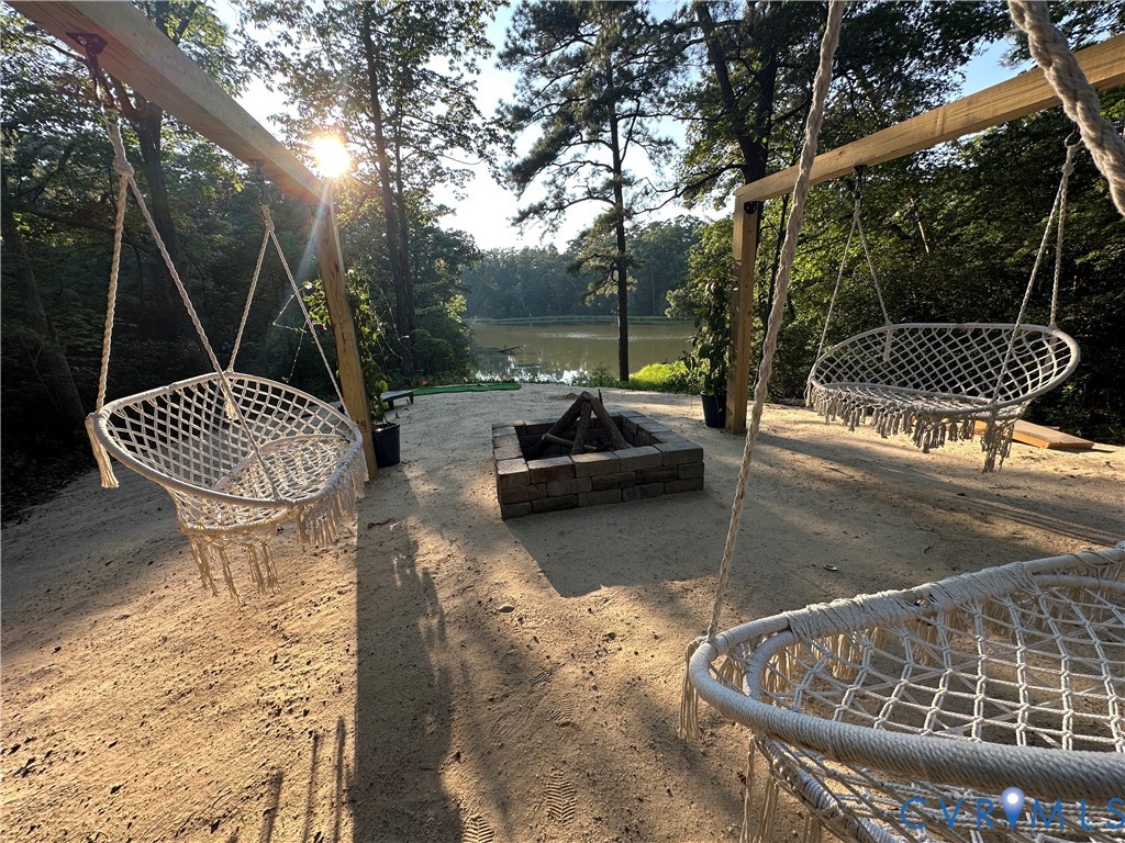 113 Rappa Run Road Topping, VA 23169 - Photo 40 of 49 View of yard featuring an outdoor fire pit, a wate