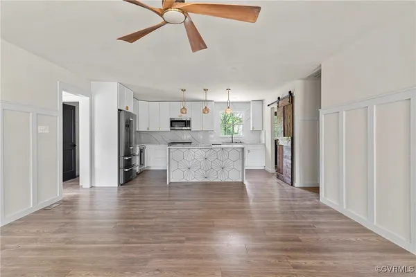 a view of a kitchen with a refrigerator a microwave and a refrigerator