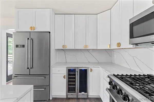 a kitchen with stainless steel appliances a refrigerator and a stove top oven