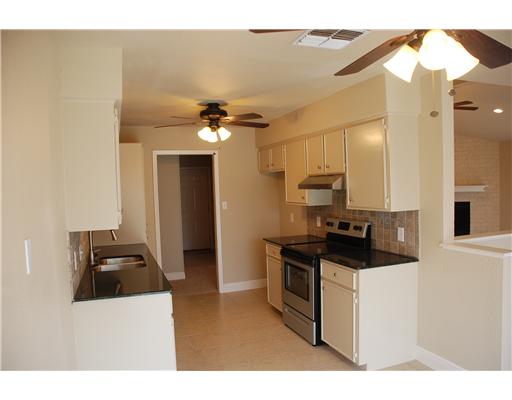 5237 Snowgoose Road Corpus Christi, TX 78413 - Photo 3 of 9 a kitchen with a sink a stove and cabinets