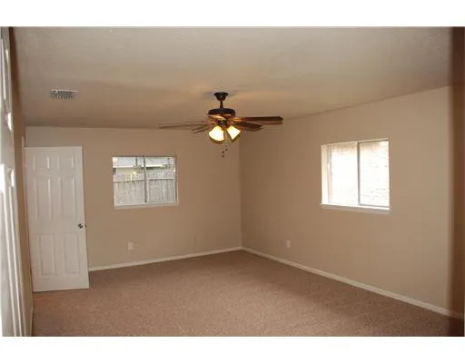 a view of a livingroom with a ceiling fan and window