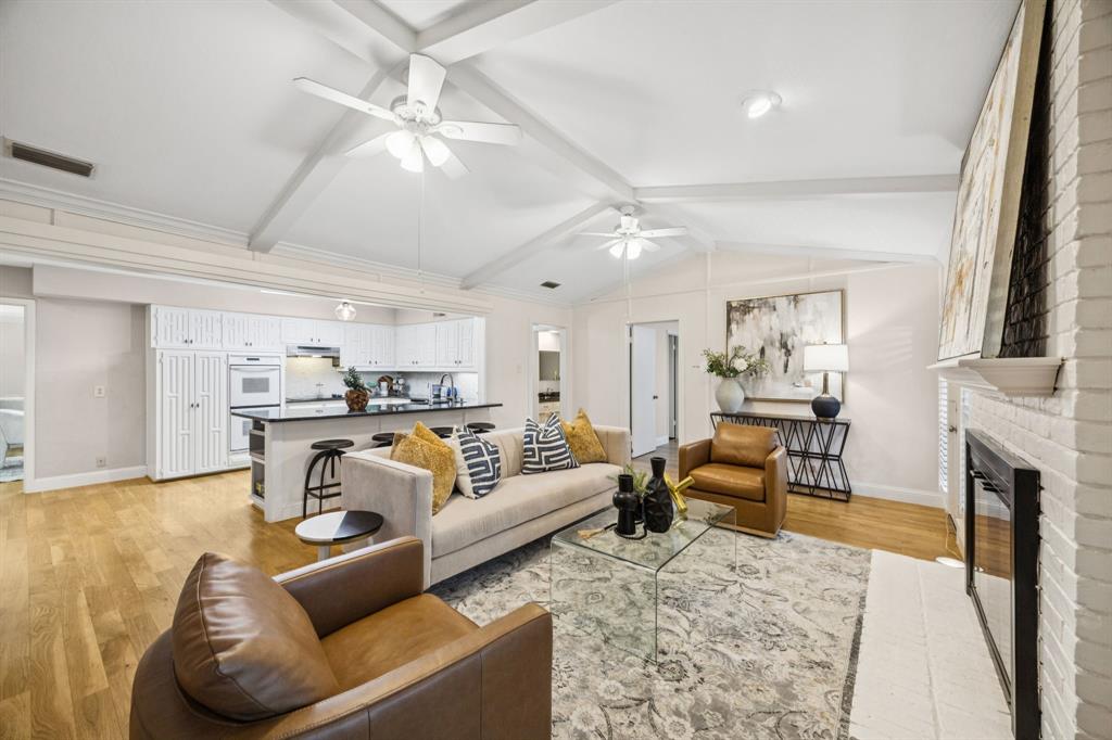 a living room with fireplace furniture and a rug
