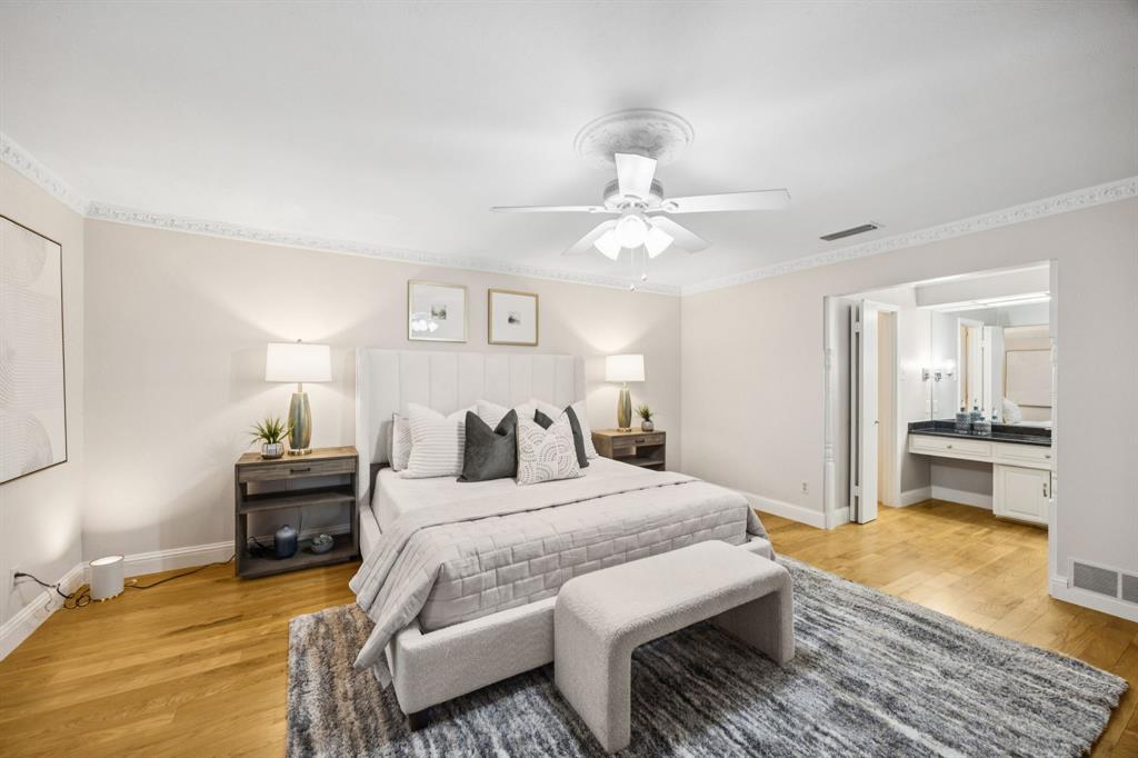 4315 Forest Bend Road Dallas, TX 75244 - Photo 14 of 29 a bedroom with a bed and wooden floor