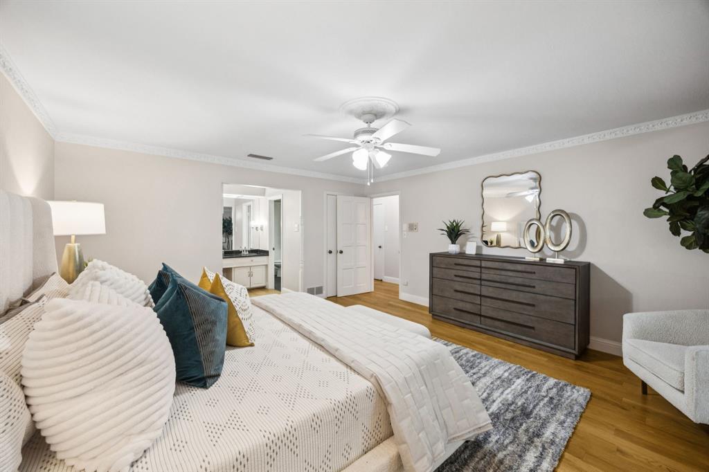 4315 Forest Bend Road Dallas, TX 75244 - Photo 15 of 29 a bedroom with a bed and wooden floor