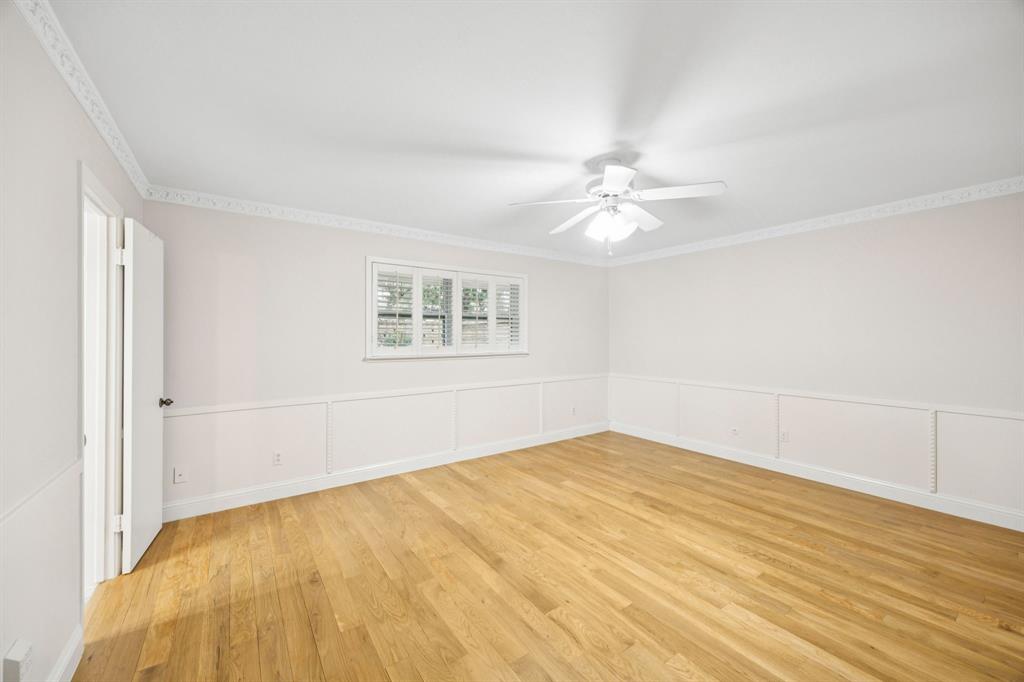 4315 Forest Bend Road Dallas, TX 75244 - Photo 21 of 29 an empty room with windows and ceiling fan
