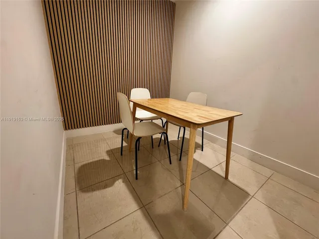 a view of a room with a table and chairs
