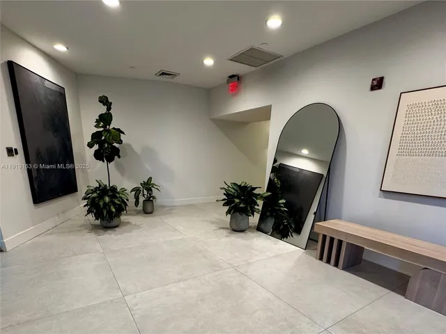 a kitchen with refrigerator and plant