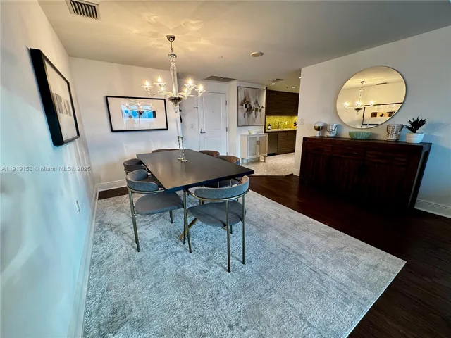 a living room with chair and a mirror