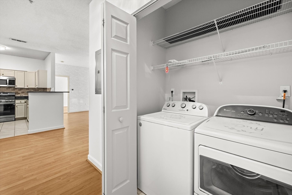 21 Hampshire Road, Unit 101 Methuen, MA 01844 - Photo 4 of 18 a view of a storage & utility room with washer and dryer