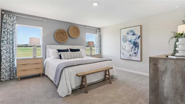 a bedroom with a bed and painting on the wall