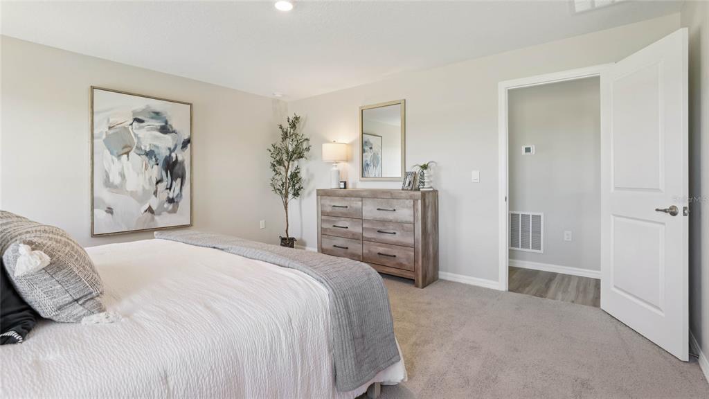 10407 Turtle Run Road Weeki Wachee, FL 34613 - Photo 17 of 31 a bedroom with a bed and a window