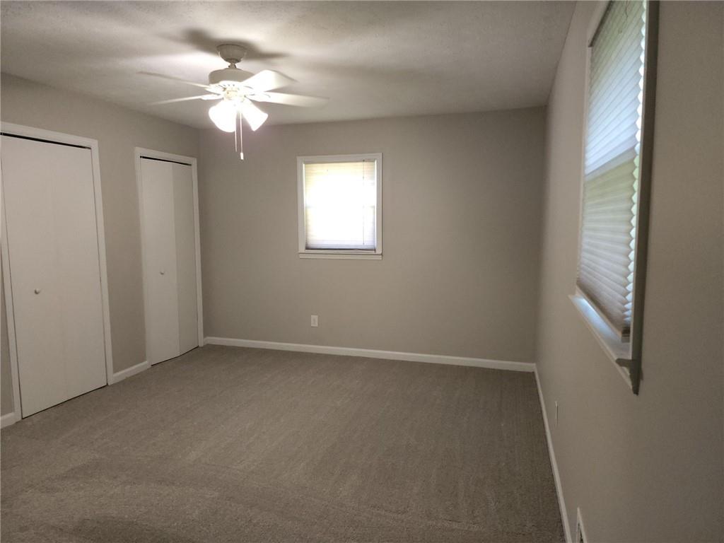 1476 Dupree Road Woodstock, GA 30189 - Photo 21 of 26 an empty room with windows and fan