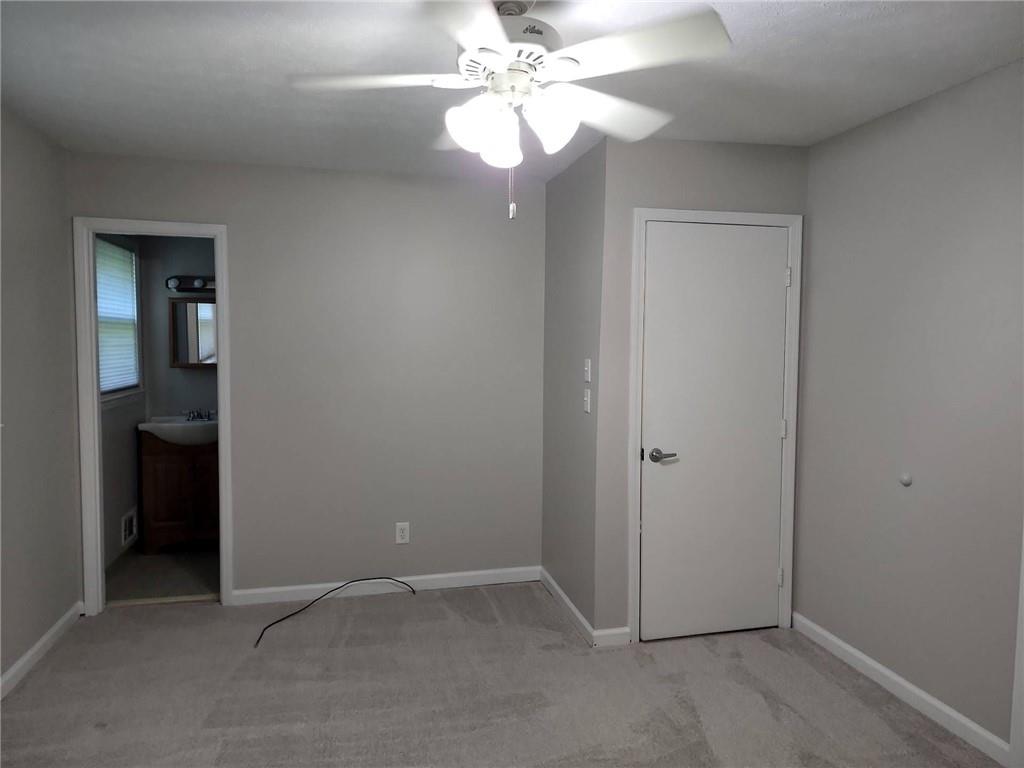 1476 Dupree Road Woodstock, GA 30189 - Photo 22 of 26 an empty room with closet and a chandelier fan