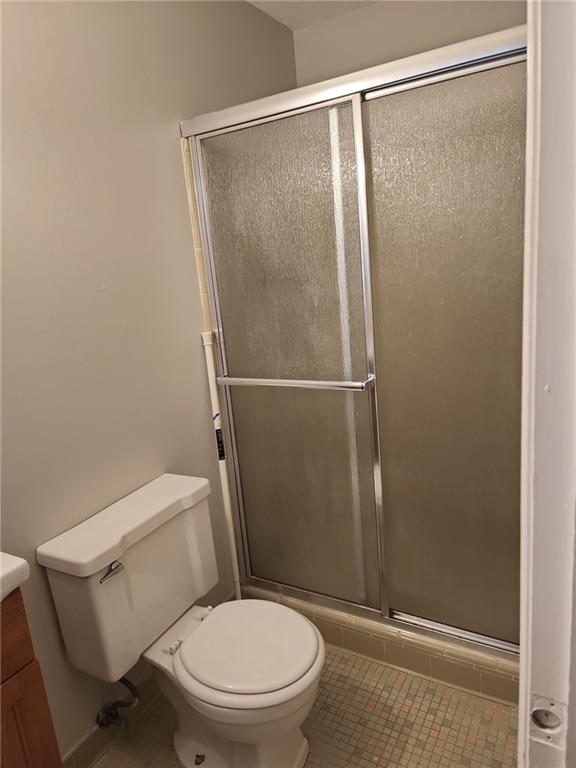 1476 Dupree Road Woodstock, GA 30189 - Photo 24 of 26 a white toilet sitting next to a shower