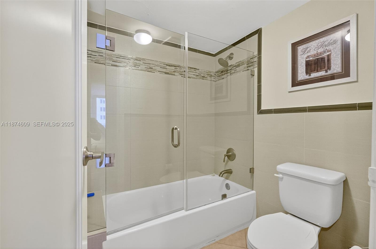 2401 Collins Avenue, Unit 1005 Miami Beach, FL 33140 - Photo 15 of 19 a bathroom with a toilet and a bathtub