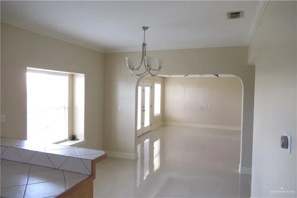 a room with window and a chandelier