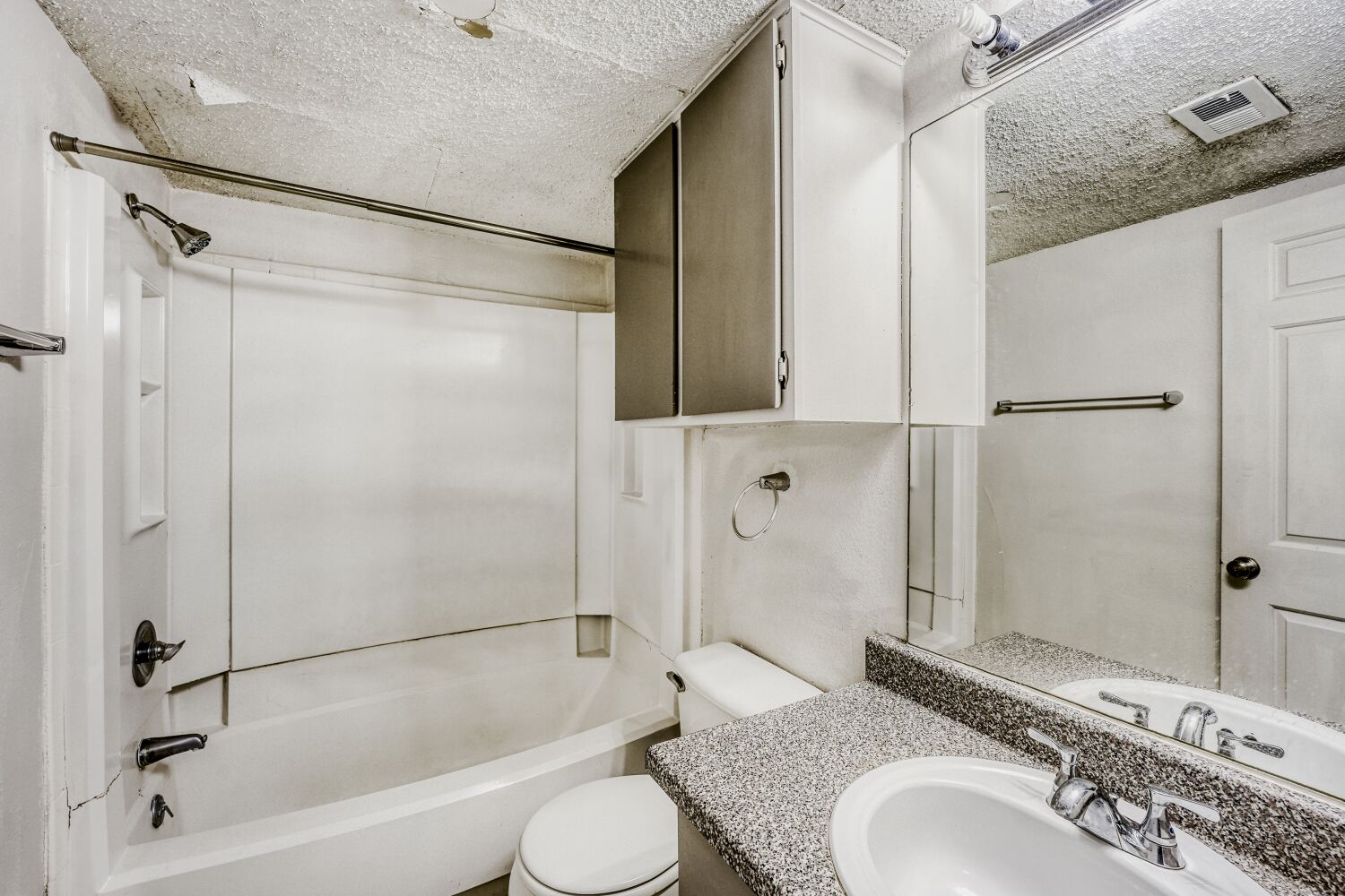 2401 Leon Street, Unit 100 Austin, TX 78705 - Photo 15 of 24 a bathroom with a granite countertop sink toilet and shower