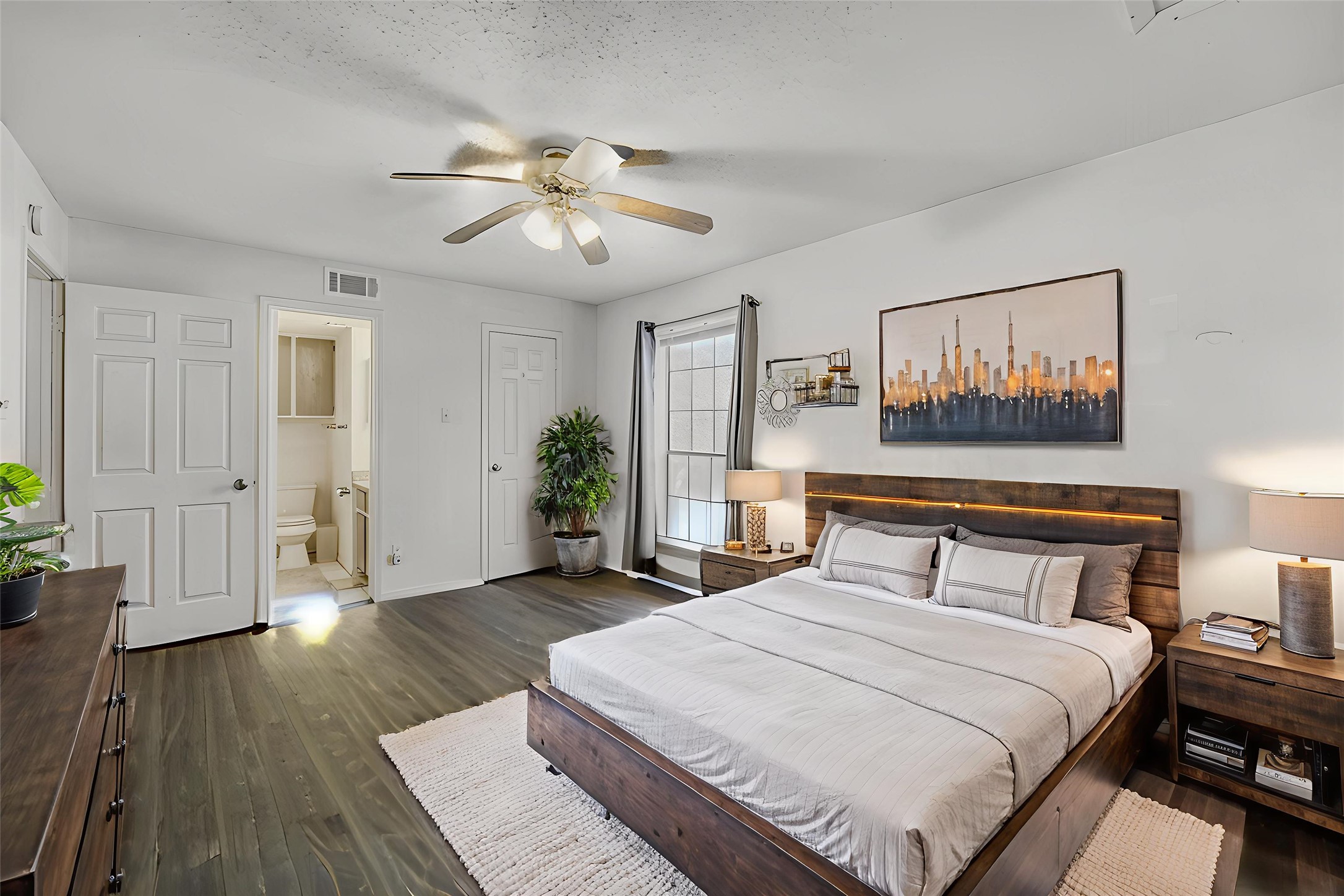 2401 Leon Street, Unit 100 Austin, TX 78705 - Photo 18 of 24 a bedroom with a bed and wooden floor
