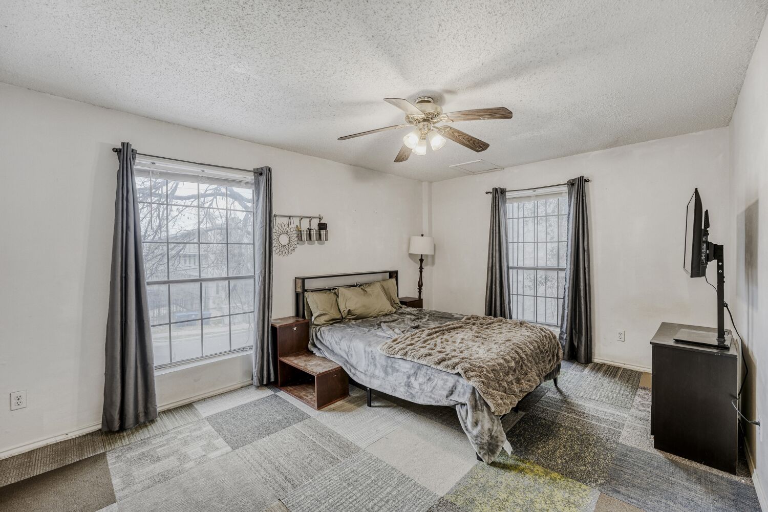 2401 Leon Street, Unit 100 Austin, TX 78705 - Photo 21 of 24 a bedroom with a bed and a flat screen tv