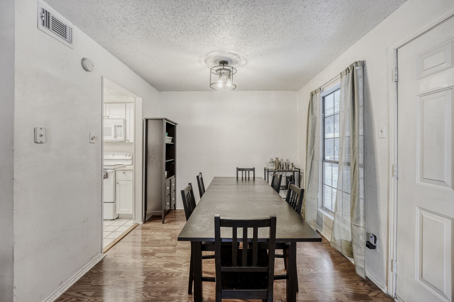 2401 Leon Street, Unit 100 Austin, TX 78705 - Photo 5 of 24 a view of a dining room with furniture and wooden floor