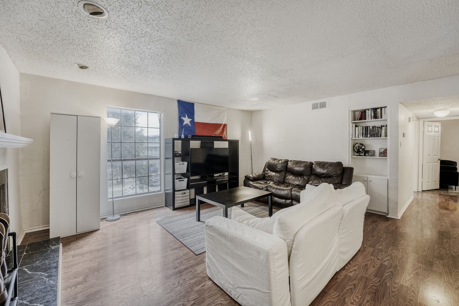 2401 Leon Street, Unit 100 Austin, TX 78705 - Photo 6 of 24 a living room with furniture a rug and a flat screen tv