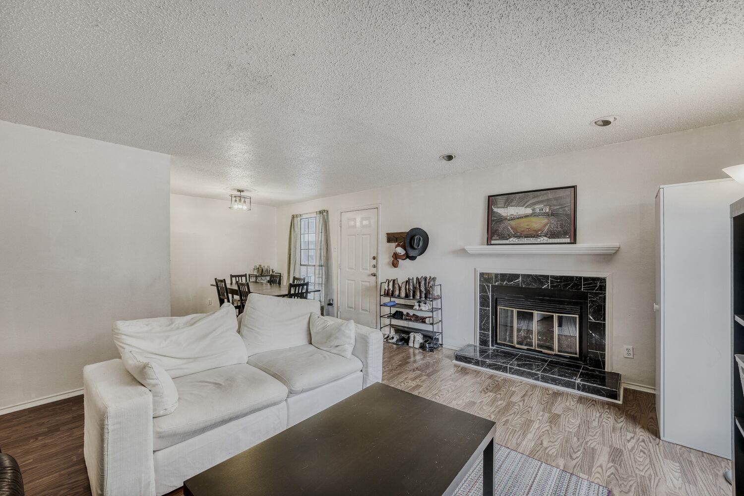2401 Leon Street, Unit 100 Austin, TX 78705 - Photo 8 of 24 a living room with furniture a fireplace and a flat screen tv