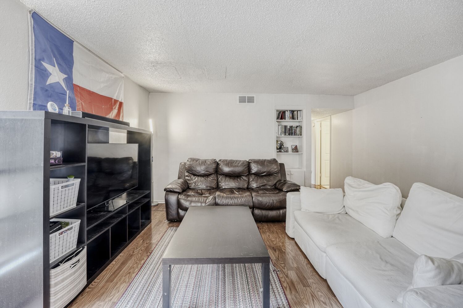 2401 Leon Street, Unit 100 Austin, TX 78705 - Photo 9 of 24 a living room with furniture a flat screen tv and a refrigerator