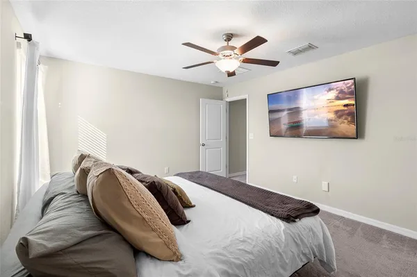 a bedroom with a bed and painting on the wall